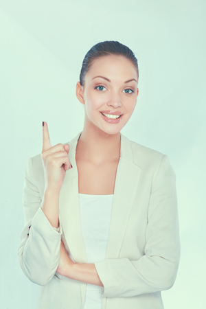 A young woman standing in white background.の写真素材