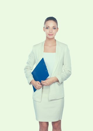 Portrait of a confident young woman standing isolated on white background.の写真素材