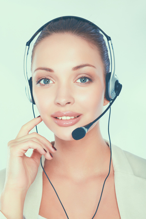 Close-up portrait of smiling young woman with headset isolated on white background.の写真素材