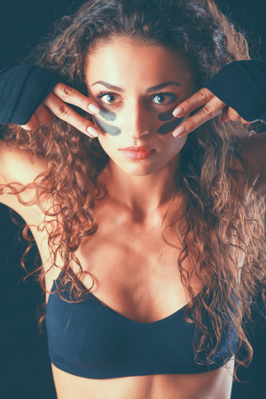 Portrait of young beautiful fitness woman, isolated on black background.の写真素材