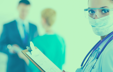 Woman doctor standing with folder at hospital .の写真素材