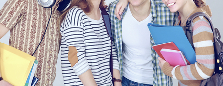 Happy group of students holding notebooks , isolated on white backgroundの写真素材