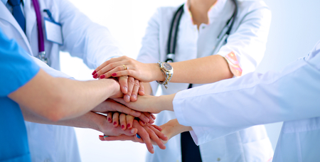 Doctors and nurses in a medical team stacking handsの写真素材