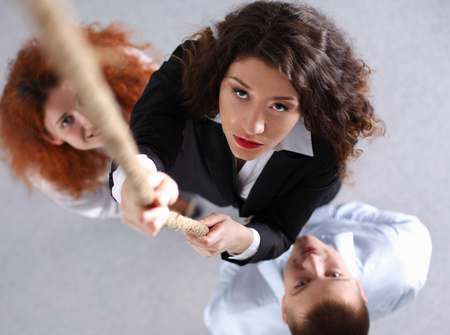 Image of businesspeople ascending up the ropeの写真素材