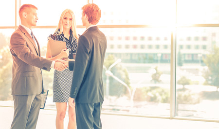 Businesswoman Shaking Hands In Officeの写真素材