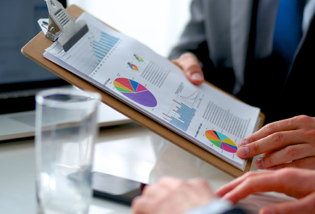 Business people sitting and discussing at business meeting, in officeの写真素材