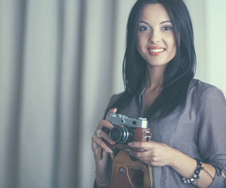 Female photographer sitting on the desk with laptopの写真素材