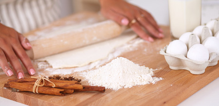 Woman is making cakes in the kitchenの写真素材