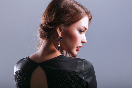 Beautiful woman with evening make-up in black dressの写真素材