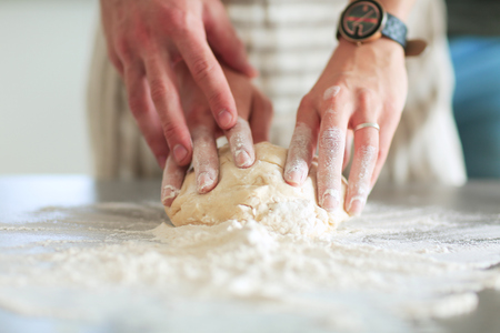 Young couple prepared cake standing in the kitchenの写真素材