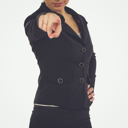 Portrait of a beautiful young woman pointing at you, isolated on white backgroundの写真素材