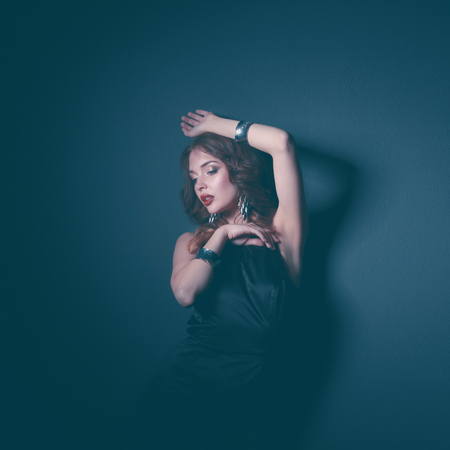 Beautiful woman with evening make-up in black dressの写真素材