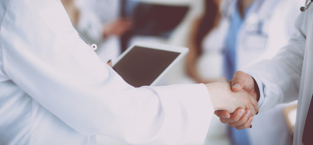 Young medical people handshaking at officeの写真素材