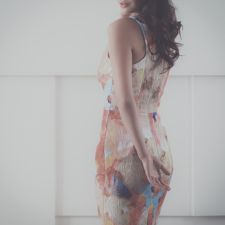 Beautiful female in sundress posing on white backgroundの写真素材