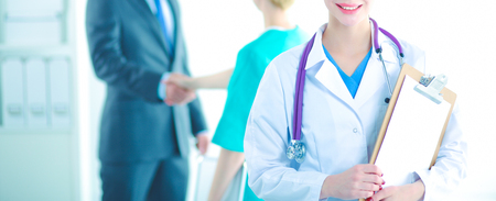 Woman doctor standing with stethoscope at hospitalの写真素材