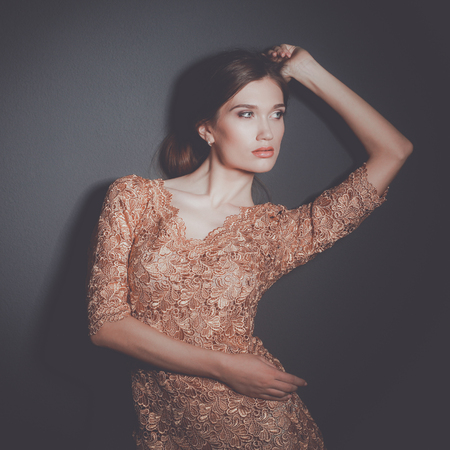 attractive woman in gold dressの写真素材