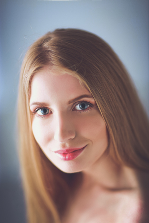 Portrait of beautiful woman isolated on gray backgroundの写真素材