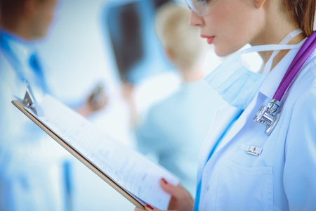 Woman doctor standing with stethoscope at hospitalの写真素材