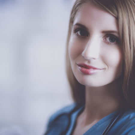 Doctor woman is standing in the near windowの写真素材