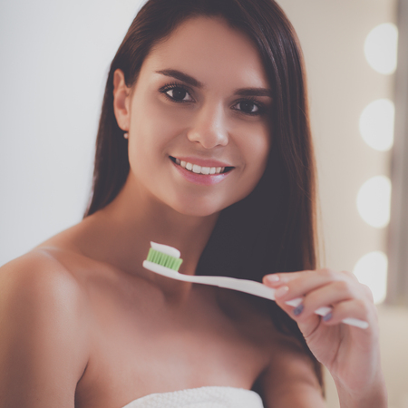 Portrait of a young girl cleaning her teethの写真素材