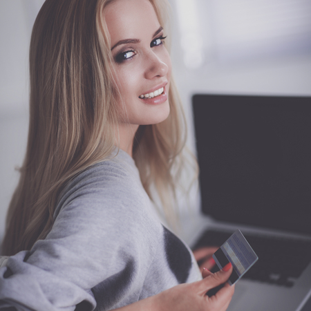 Young beautiful woman using a laptop computer at homeの写真素材