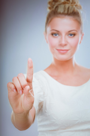 Portrait of a confident young woman standing isolated on white backgroundの写真素材