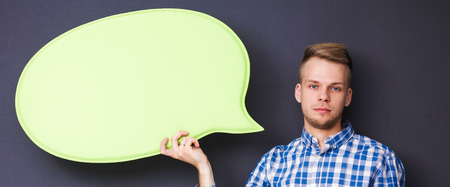 Man holding white blank speech bubble with space for text,の写真素材