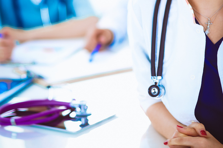 Attractive female doctor in front of medical groupの写真素材