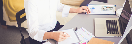 Young businessman working in office, sitting near deskの写真素材