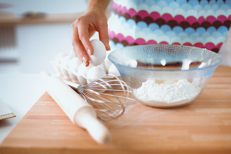 Woman is making cakes in the kitchenの写真素材