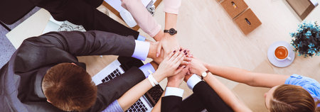 Business team with hands together - teamwork concepts