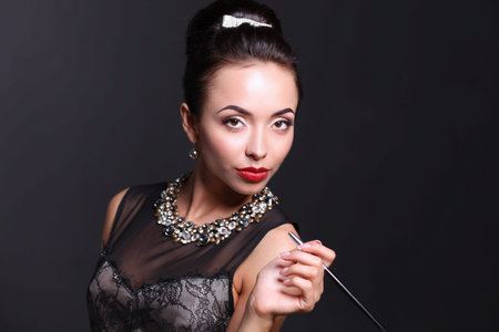 Retro woman portrait, standing on the black background