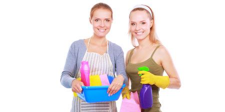 Two women is cleaning something with wisp and spray attentively.の写真素材