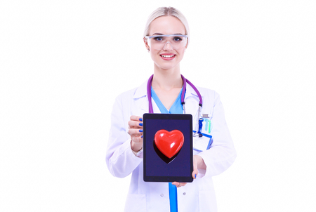 Young woman doctor holding a red heart, isolated on white backgroundの写真素材
