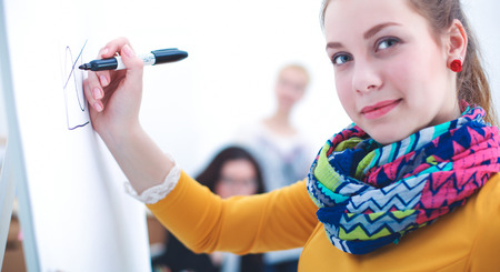 Young woman standing near board with folderの写真素材
