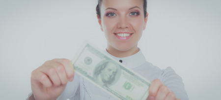 A young woman with dollars in her hands, isolated on white backgroundの写真素材