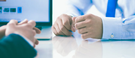Business people sitting and discussing at business meeting, in office