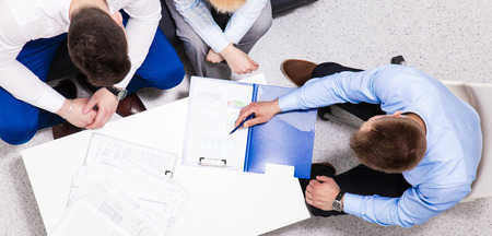 Business people sitting and discussing at business meeting, in officeの写真素材