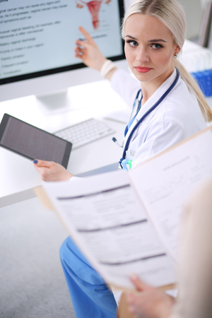 Doctor and patient discussing something while sitting at the table . Medicine and health care concept. Doctor and patientの写真素材