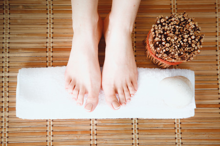 Care for beautiful woman legs on a towel. Beautiful woman legsの写真素材