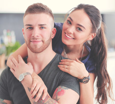 Beautiful young couple is having fun in kitchen at homeの写真素材