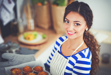 Woman is making cakes in the kitchenの写真素材