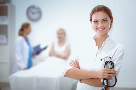 Portrait of woman doctor standing at hospitalの写真素材
