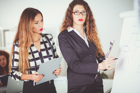 Business people sitting and discussing at business meeting, in office. Business peopleの写真素材