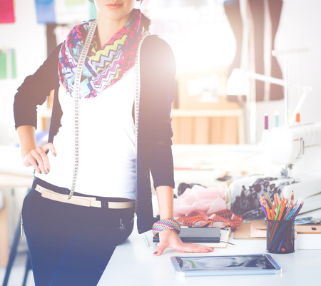 Beautiful fashion designer standing in studioの写真素材