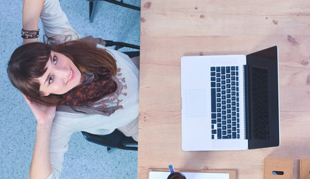 Business woman relaxing with  hands behind her head and sitting on a chairの写真素材