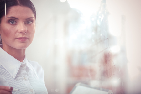 Young woman drawing on whiteboard with white copyspace. Young womanの写真素材