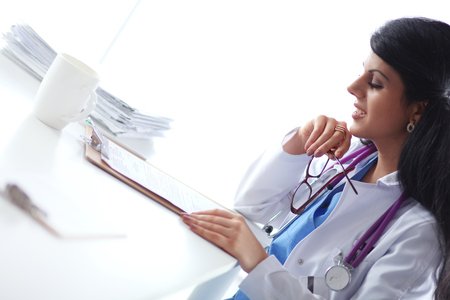Woman with documents sitting on the deskの写真素材