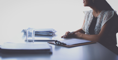Woman with documents sitting on the deskの写真素材