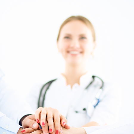 Doctors and nurses in a medical team stacking handsの写真素材